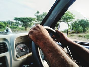 Midsection of man driving car