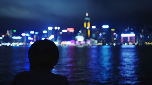 Silhouette of people in city at night