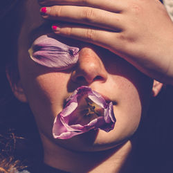 Close-up of woman covering eyes