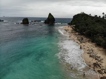 High angle view of rocks in sea against sky