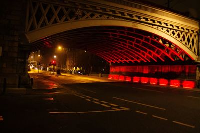 Illuminated bridge against sky at night