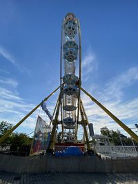 Low angle view of ferris wheel against sky