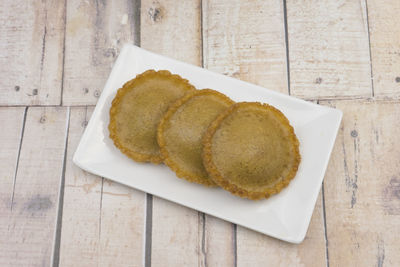 Kueh penyaram, traditional dessert of borneo on the wooden background.