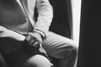 Midsection of man sitting at home