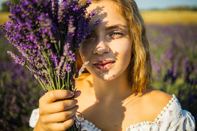Portrait of young woman with lavender flowers