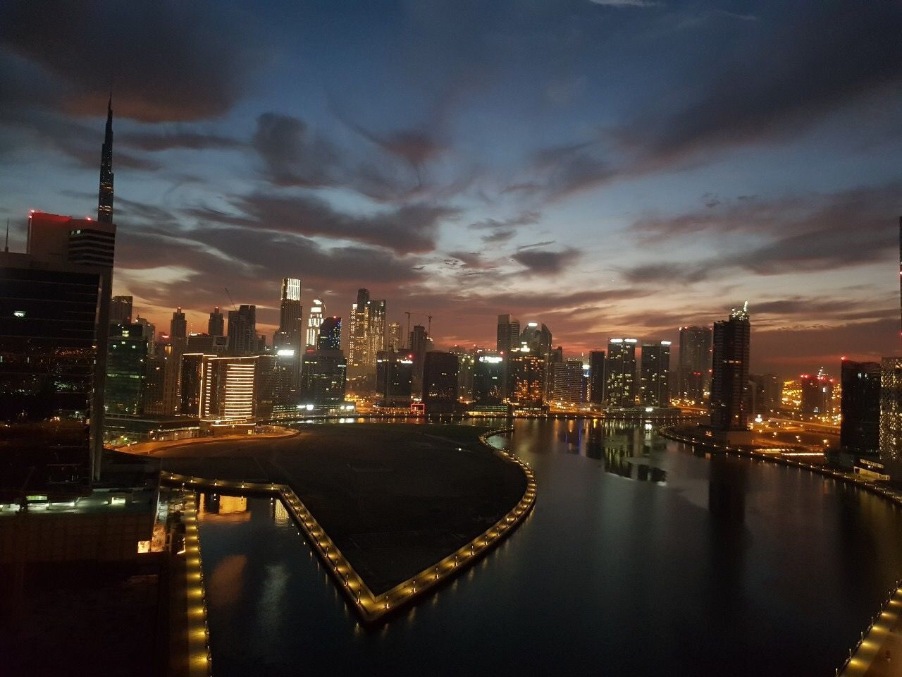 ILLUMINATED BUILDINGS AT WATERFRONT