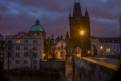 Illuminated buildings against sky at night