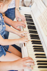Girl with parents playing piano
