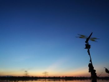 Low angle view of flowering plants against clear blue sky