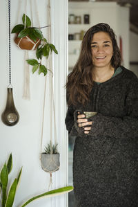 Portrait of a smiling young woman holding food