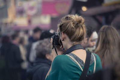 Female photographer taking shot of street