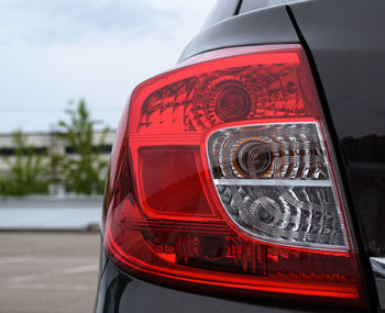 Close-up of red car against sky