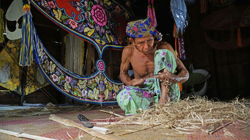 Man working in traditional clothing