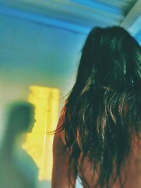 Rear view of woman looking at window