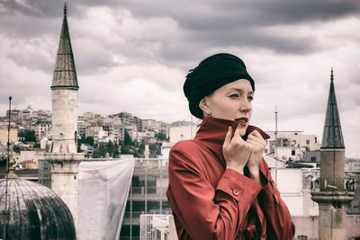 Portrait of city against cloudy sky