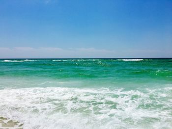 Scenic view of sea against clear blue sky