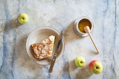 Apples and apple pie slices, top view