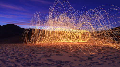 Wire wool on landscape against sky