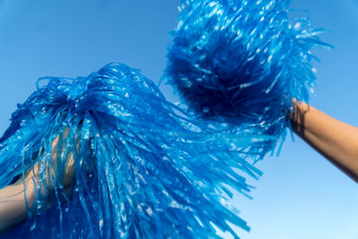 Close-up of hand holding blue leaf