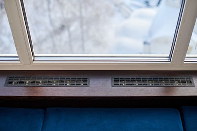 Windowsill, heating grid ventilation. winter apartment heating. modern double glazed windows