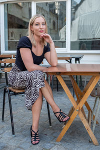 Young woman sitting on chair at home