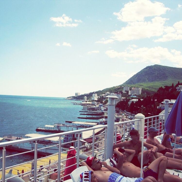 sea, horizon over water, water, sky, beach, built structure, building exterior, architecture, shore, day, high angle view, nature, nautical vessel, railing, scenics, vacations, outdoors, incidental people, coastline, mountain