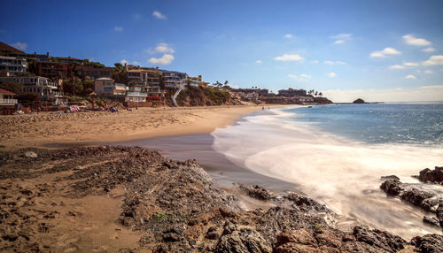 Scenic view of beach against cloudy sky