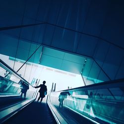 Rear view of silhouette woman walking on staircase