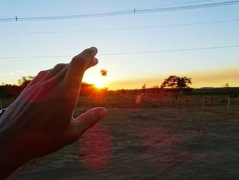 Silhouette of person standing on field during sunset