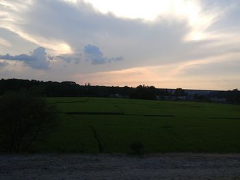 Scenic view of field against sky during sunset