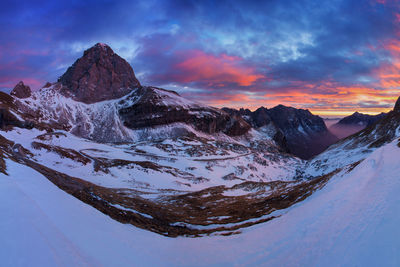 Scenic view of snowcapped mountains against sky during sunset