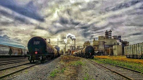 Railroad track against cloudy sky