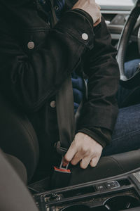 Midsection of man sitting in car