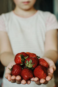 Close-up of hand holding strawberries