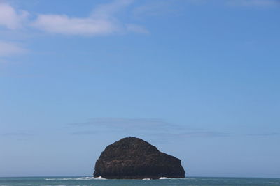 Rock formation amidst sea against sky
