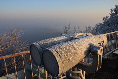 Close-up of binoculars at observation point during winter