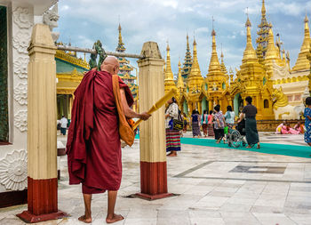 People at temple outside building