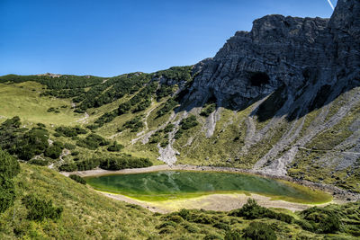 Scenic view of mountains against clear blue sky