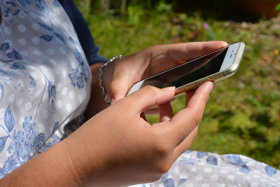 Midsection of woman using mobile phone