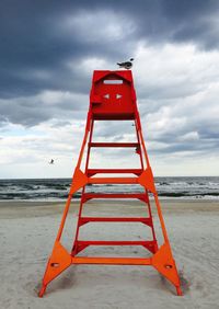 View of beach against cloudy sky