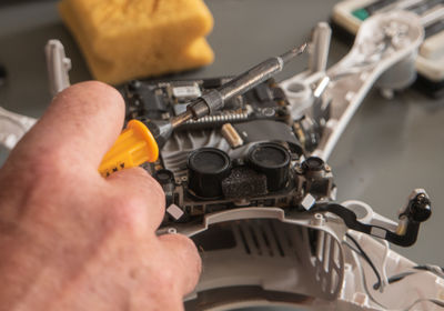 Close-up of man working on metal