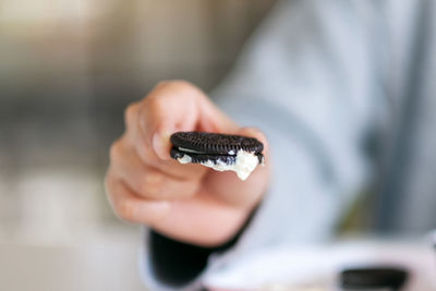 Close-up of hand holding cigarette