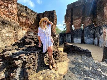 Woman standing by old ruins