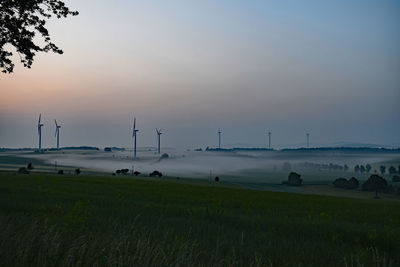 Scenic view of field against sky during sunset