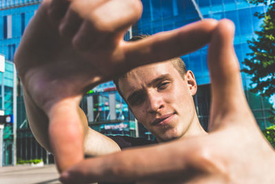 Portrait of young man making face outdoors