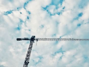 Low angle view of crane against sky