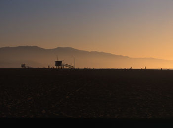 Scenic view of field against sky during sunset
