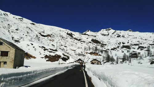 Scenic view of snow covered mountain against cloudy sky