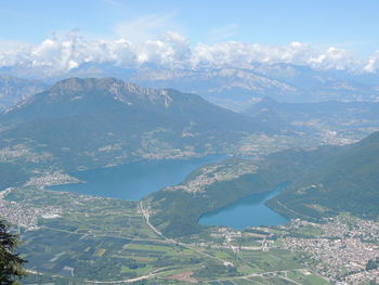 Aerial view of city and mountains against sky
