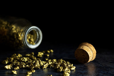 Close-up of wine glass on table against black background